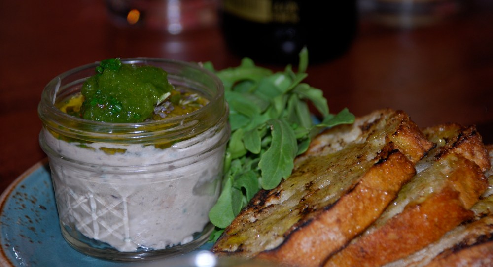 This is a side dish of smoked fish pâté and toast.  The arugula is perfect on top.  You might think you don't like fish pâté but try it, it's so good.