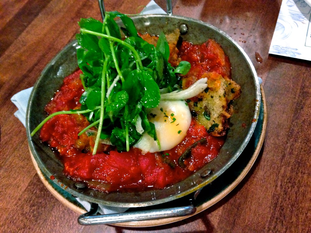This shakshouka is topped with pea greens, spiced with harissa and has nice, briny anchovy croutons rounding out the flavours.