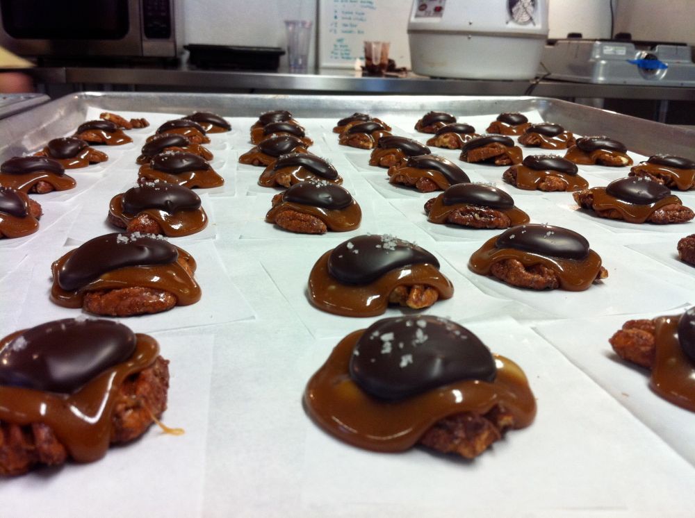 Behind the scenes at EHChocolatier.  These pecan clusters with bourbon caramel disappear in the blink of an eye.